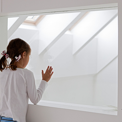 Girl looking through inside window